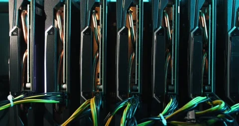 The camera moves back showing a home mining farm with vga cards in a blue light Stock Footage 155567640