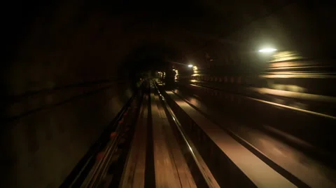 Camera Moves Backward along Metro Rails in Dark Tunnel Stock Footage 62753806
