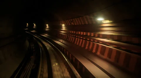 Camera Moves Backward along Metro Rails in Dark Tunnel Stock Footage 62753808