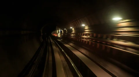 Camera Moves Backward along Metro Rails in Dark Tunnel Stock Footage 62753813