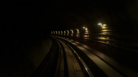Camera Moves Backward along Metro Rails in Dark Tunnel Stock Footage 62753817