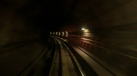 Camera Moves Backward along Metro Rails in Dark Tunnel Stock Footage 62795892