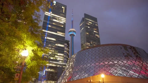 Camera Moves Backward Revealing CN Tower Beside Roy Thomson Hall at Dusk Stock Footage 342750517
