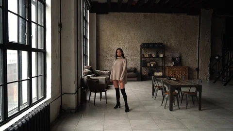 The camera moves to a beautiful Asian model, over the loft space. Stock Footage 107320323