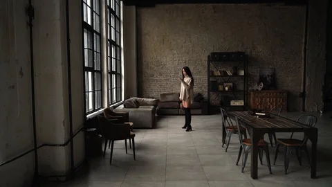 The camera moves to a beautiful Asian model, over the loft space. Stock Footage 107320386