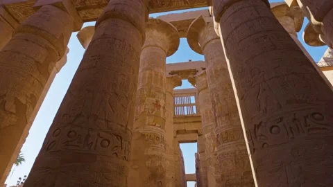 Camera moves between columns with ancient Egyptian drawings. Karnak Temple in 動画素材 195449755