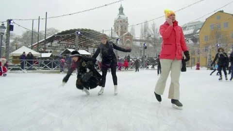 Camera moves between crowd of people ice skating in a rink, fall on the ground Video stock 70640688