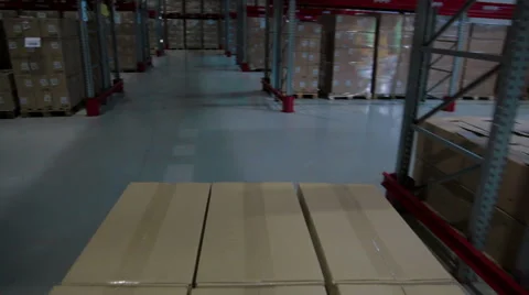 Camera moves between palettes with boxes warehouse Video stock 62388252