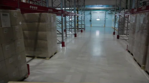 Camera moves between palettes with boxes warehouse Stock Footage 62396912