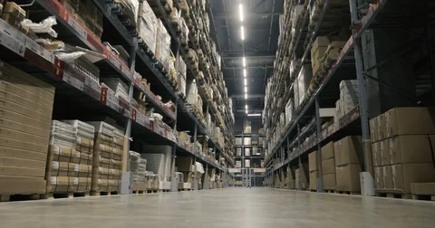 Camera moves between palettes with cardboard boxes and different materials in a Stock Footage 85322933