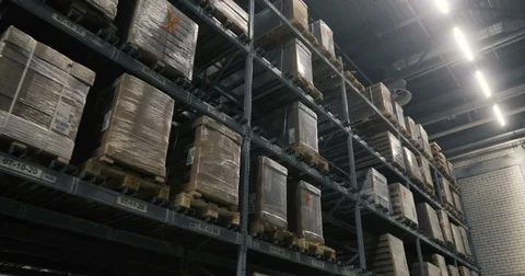 Camera moves between palettes with cardboard boxes and different materials in a Video stock 85323664