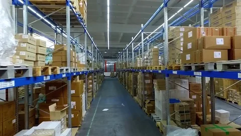 Camera moves between shelves boxes storage warehouse HD interior video Stock Footage 72219301