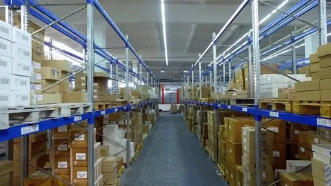 Camera moves between shelves boxes in storage warehouse interior HD video Stock Footage 72219316