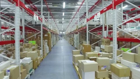 Camera moves between shelves cardboard boxes storage warehouse interior HD video Stock Footage 72219397