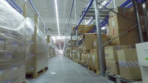Camera moves between shelves cardboard boxes storage warehouse interior HD video Stock Footage 72219417