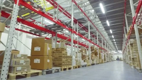 Camera moves between shelves cardboard boxes storage warehouse HD video Stock Footage 72219427