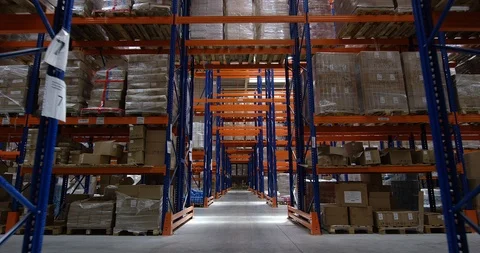 Camera moves between shelves with palettes and boxes in a big modern logistic Stock Footage 109794605