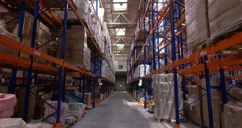 Camera moves between shelves with palettes and boxes in a big modern logistic Stock Footage 109798170