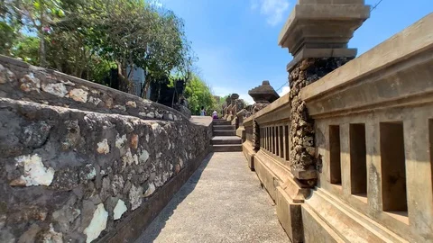The camera moves between a stone fence and a powerful wall to the stairs Stock Footage 122125703