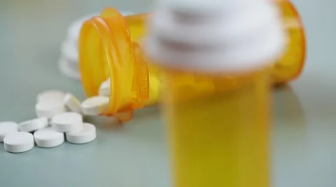 Camera moves from bottle to bottle of pills Stock Footage 62184484