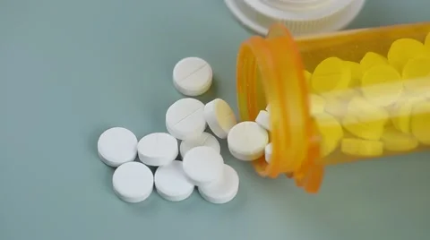 Camera moves from bottle to bottle of pills Stock Footage 62184491