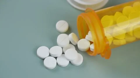 Camera moves from bottle to bottle of pills Stock Footage 62184492