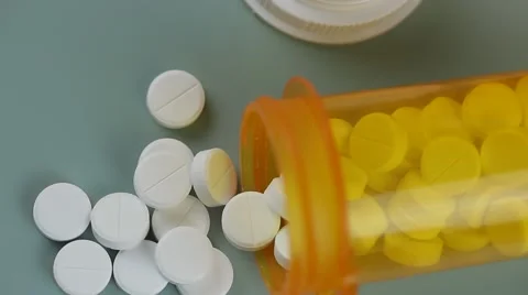 Camera moves from bottle to bottle of pills Stock Footage 62184499