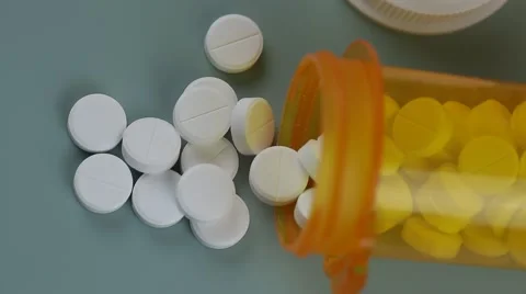 Camera moves from bottle to bottle of pills Stock Footage 62184509