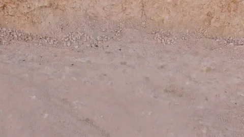 The camera moves from the bottom of a deep sand pit up. Vídeo Stock 117699878