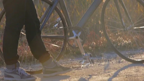 Camera moves from bottom to top of young man in the field at sunset autumn time Stock Footage 86295440