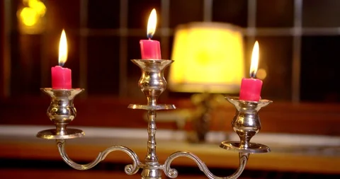 The camera moves from the burning candles to a man's hand with a glass   Stock Footage 130130316