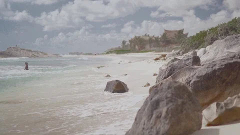 The camera moves close to the beach sand along the coastline, stones close-up. Stock-Footage 128934310