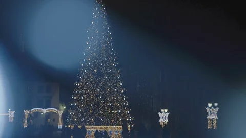 Camera moves down from behind the Christmas lights and shows us a beautiful, Stock-Footage 108458484