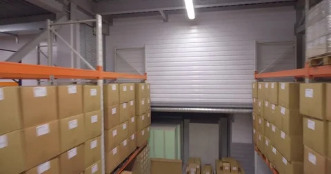 Camera moves down between warehouse racks 库存影片 82412565