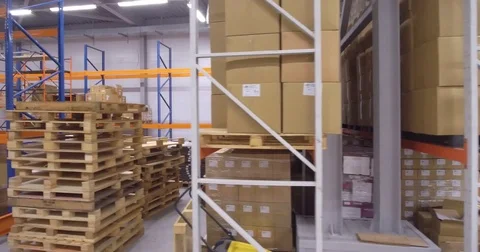 Camera moves down between warehouse racks 库存影片 82412693