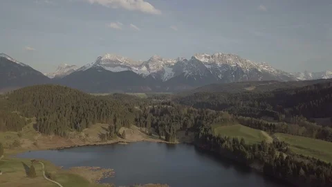 Camera moves down in front the amazing panoramic mountain view with the lake Stock Footage 89763299