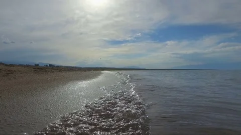 The camera moves forward along the shore of Issyk-Kul Stock Footage 85265560