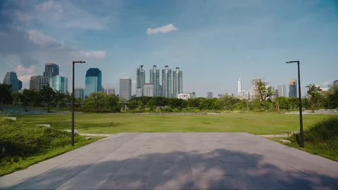 Camera moves forward along an urban landscape with skyscrapers in a green empty Stock Footage 246854531