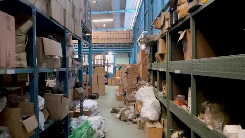 Camera moves forward between shelves with box with stuff in logistic Video stock 249259268