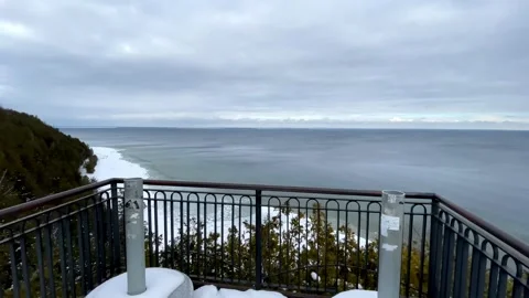 Camera moves forward on a snowy balcony to show a beautiful winter sea landscape Stock-Footage 325478185