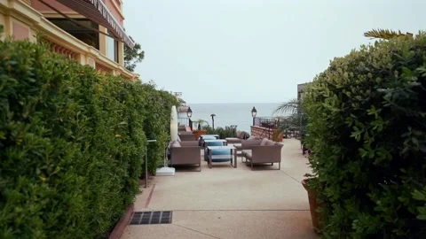 The camera moves forward through the green fence towards the sea. Stock Footage 301282828