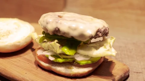 Camera Moves In Front Of A Fresh Unappetizing  Hamburger Stock Footage 127023267