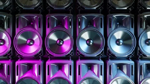 Camera moves up in front of a row of working loudspeakers ultraviolet light Stock Footage 285900073