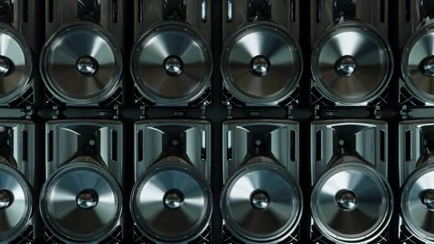 Camera moves up in front of a row of working loudspeakers Stock Footage 285900077