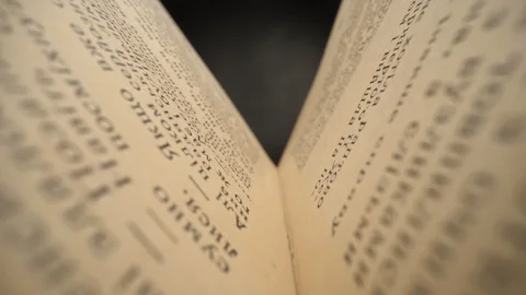 Camera moves inside the book. Old book sways in the wind. Slider shot with probe 스톡 동영상 129494934