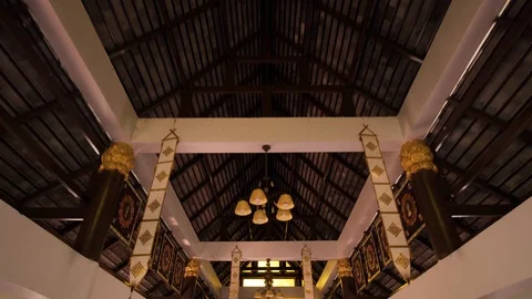 Camera moves inside Thai Buddhist Temple and panning directly to the Golden Stock Footage 88285657