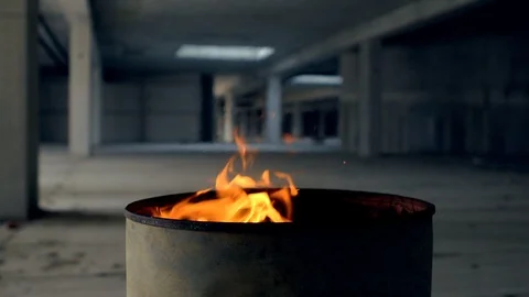 The camera moves from left to right around orange flames of fire burning in a Stock Footage 90210156