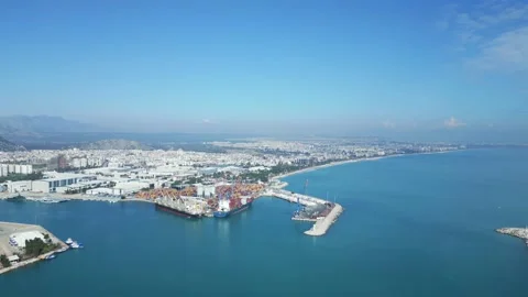 The camera moves from left to right making a panorama of a small cargo seaport Stock Footage 233155994