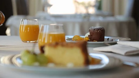 Camera moves over the breakfast table, at the end it focuses on the cupcakes Stock Footage 128570681