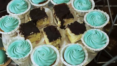 Camera moves over the candy bar from cheesecakes to turquoise cupcakes Stock Footage 132144464